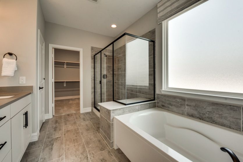 Owner's bath with large tub and tile-surround shower