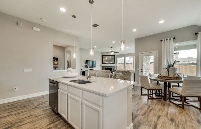 Large island overlooking gathering room and breakfast nook