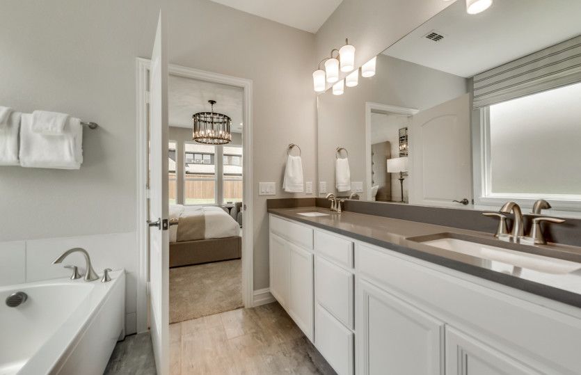 Owner's bath with double vanity and tile flooring *model representation