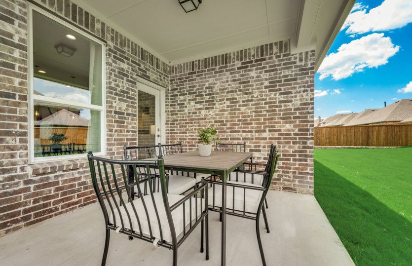 Spacious covered patio overlooking fenced-in backyard