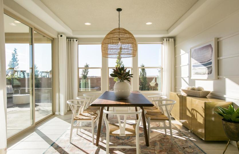 The well-lit cafe features a tray ceiling with decorative accents and access to the backyard and cov