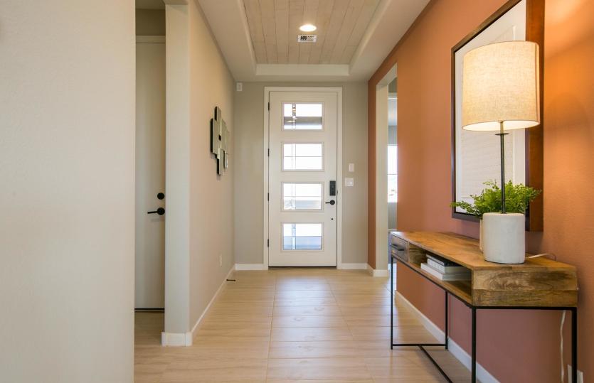 Welcome to the Tifton Walk home design with accented tray ceiling in the foyer and modern front door.