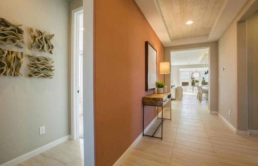 Through the front door you'll find the secondary bedrooms to the left and open living areas straight
