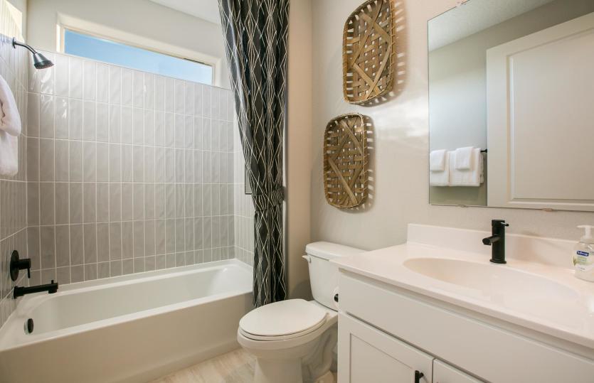 Guest bathroom complete with cultured marble counters and a combined bath tub and shower configurati