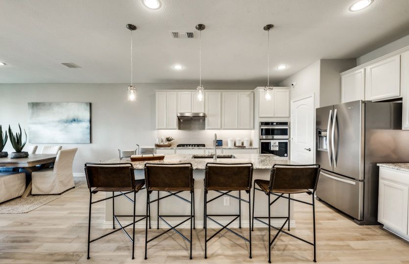 Gorgeous and spacious kitchen with eat-in bartop and recessed lighting*model representation
