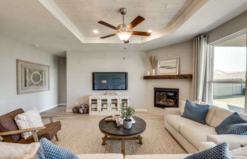 Spacious gathering room with tray ceiling*model representation