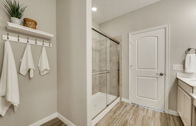 Spacious owner's bath with large shower*model representation