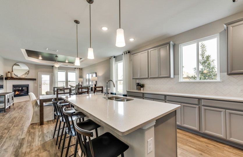 View of dining and gathering room from kitchen island*model representation