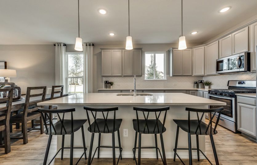 Gorgeous kitchen with recessed and pendant lighting*model representation