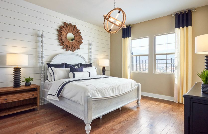 Owner's suite dressed up with a decorative light fixture and headboard wall detail.