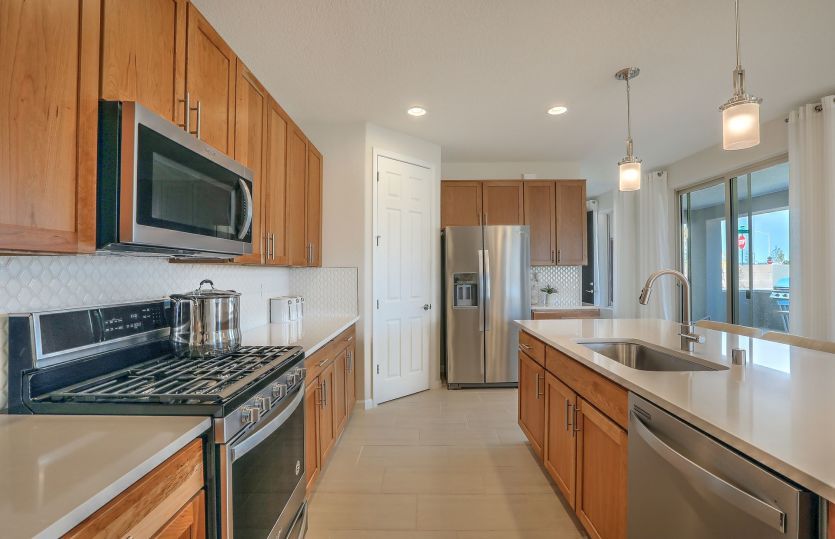An oversized corner pantry plus lots of cabinet space provides families with plenty of storage optio