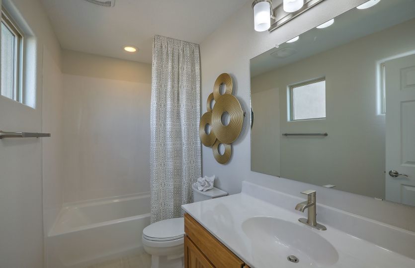 Secondary bathroom upstairs serves bedrooms 2 and 3 and is complete with a shower/tub combination.