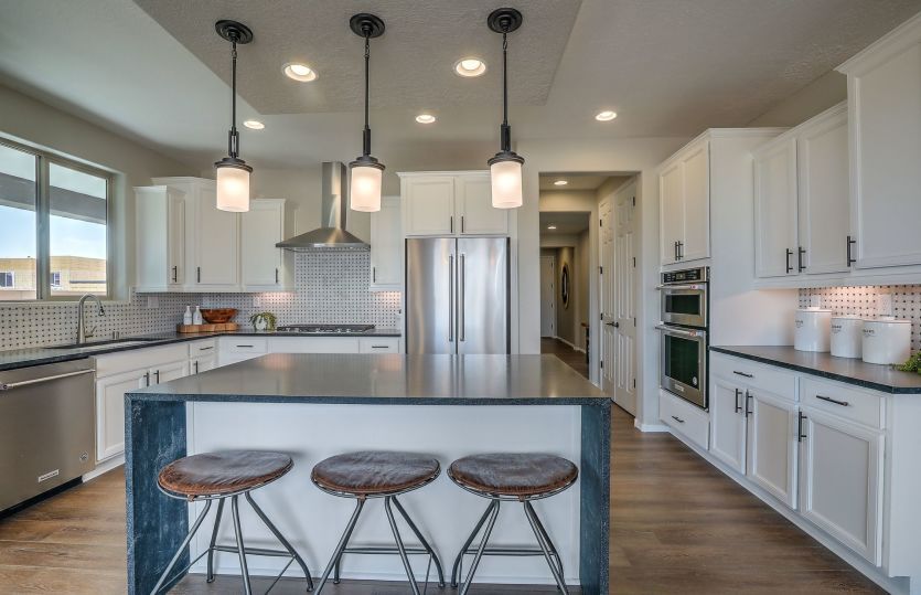 The Ocotillo kitchen with our Chef package that includes staggered cabinetry and built-in appliances