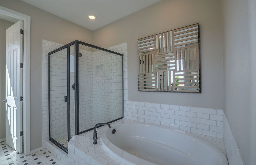 Unwind from the day in your dreamy tile bathtub in the owner's suite bath.