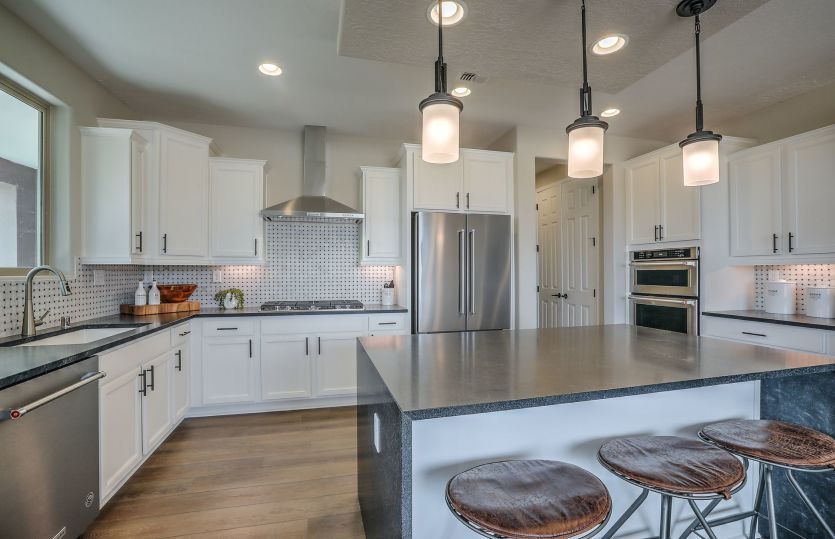 Give your kitchen an impressive look with the waterfall island option and granite countertop.