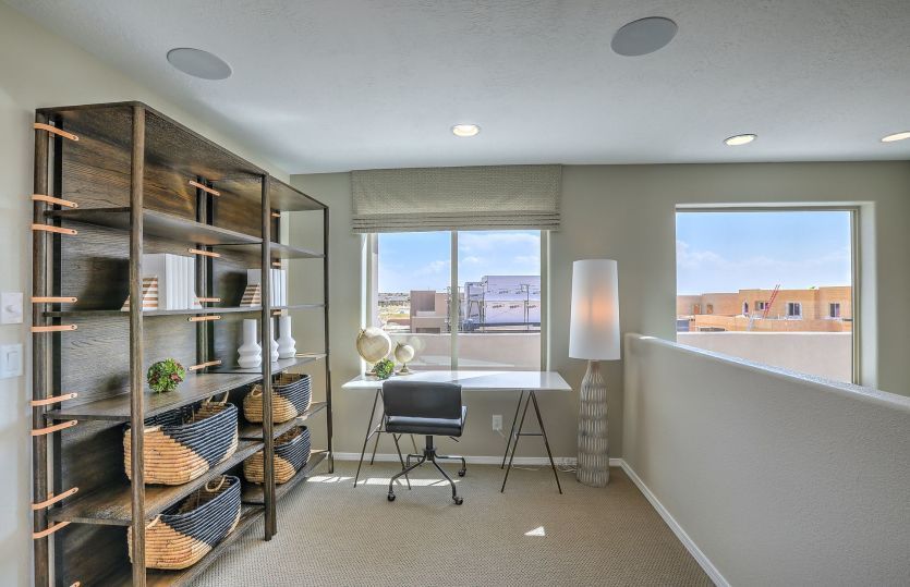 The loft upstairs makes another flexible living area on this home design for a home office, home gym