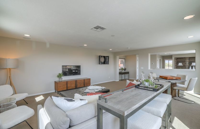 The added game room option designed with a mini bar, dart board and game table are a few ways to use