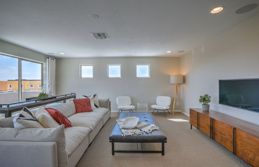 Game room serves as a multi-functional space for family game and movie nights, or working and studyi