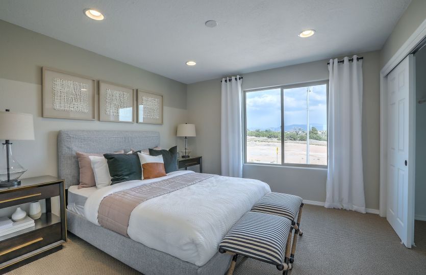 Bedroom 2 on the second floor with spacious closet and views out the bright window.