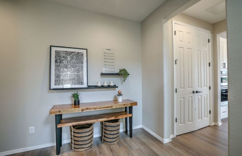 Entry off the two-car garage leads to first floor owner's suite, laundry and into kitchen.
