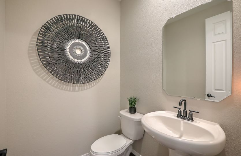 First floor powder bath serves visiting guests and is easily accessible from the kitchen and gatheri