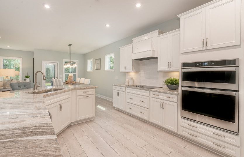 Large gourmet kitchen with tile floors and Quartz countertops