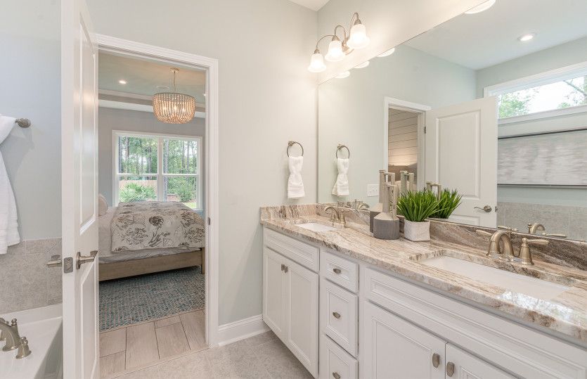 Owner's bathroom with double vanities and tile floors