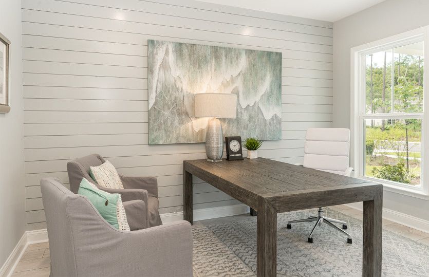 Home office with double french doors and shiplap accent wall