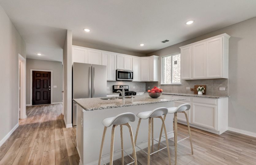Entry into spacious kitchen with eat-in island *Model representation