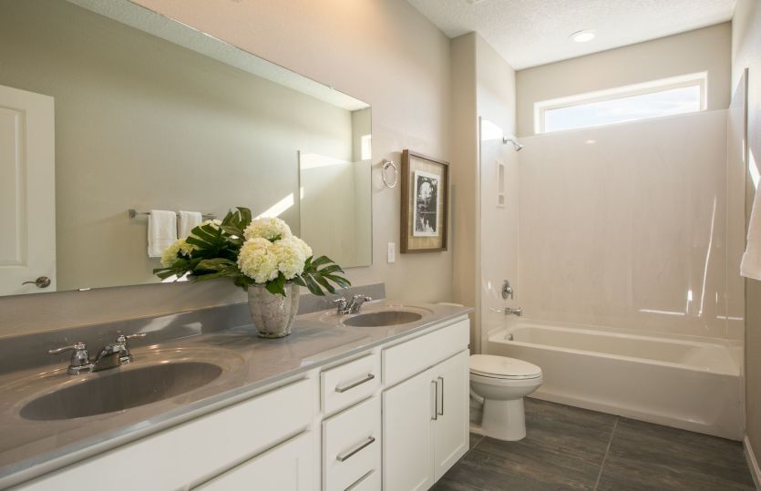 The secondary bath upstairs includes an optional second sink, marble countertops and the option to u