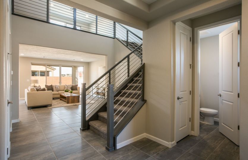 The first floor of the Trento includes a powder bath for guests, plus a stair set to the second floo