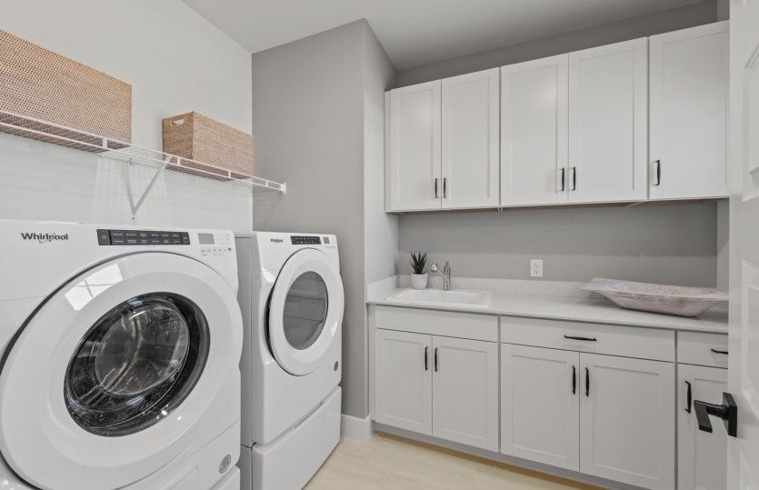 Laundry with storage and optional sink on second floor of home
