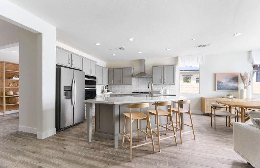 Beautiful kitchen shown here with gray cabinets, stainless-steel appliances, and tile backsplash.