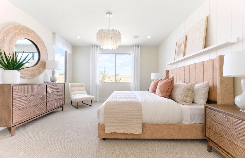 Beautiful owner's suite shown here with trim detail, a built-in shelf, and decorative lighting fixtu