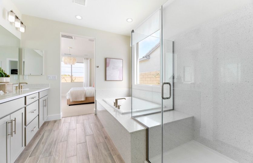 Owner's bath complete with a double sinks, a large tub, and separate walk-in shower.