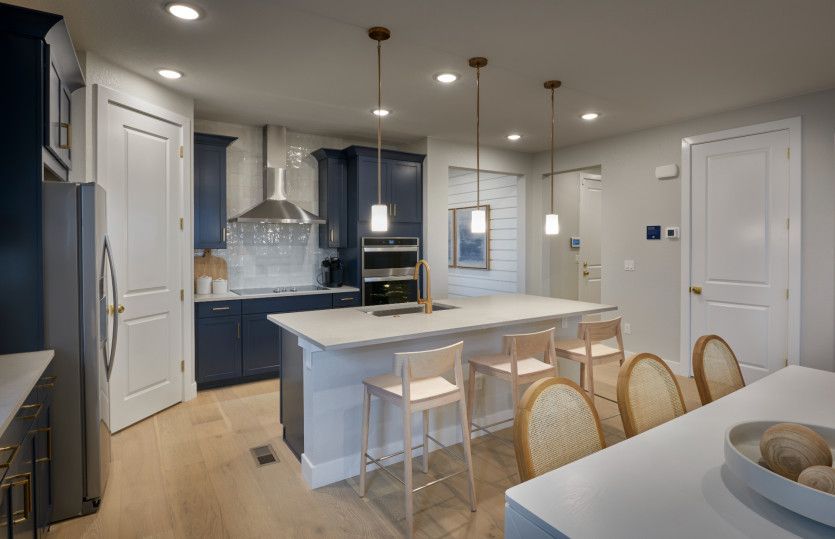 Enjoy your coffee each morning at the kitchen island with overhead pendant lighting.