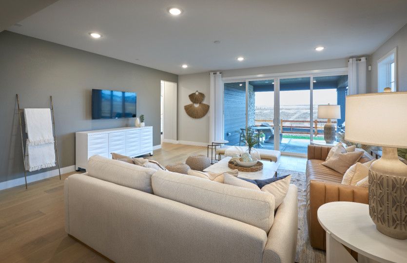 The sliding glass door and large windows allow for ample natural light throughout the gathering room