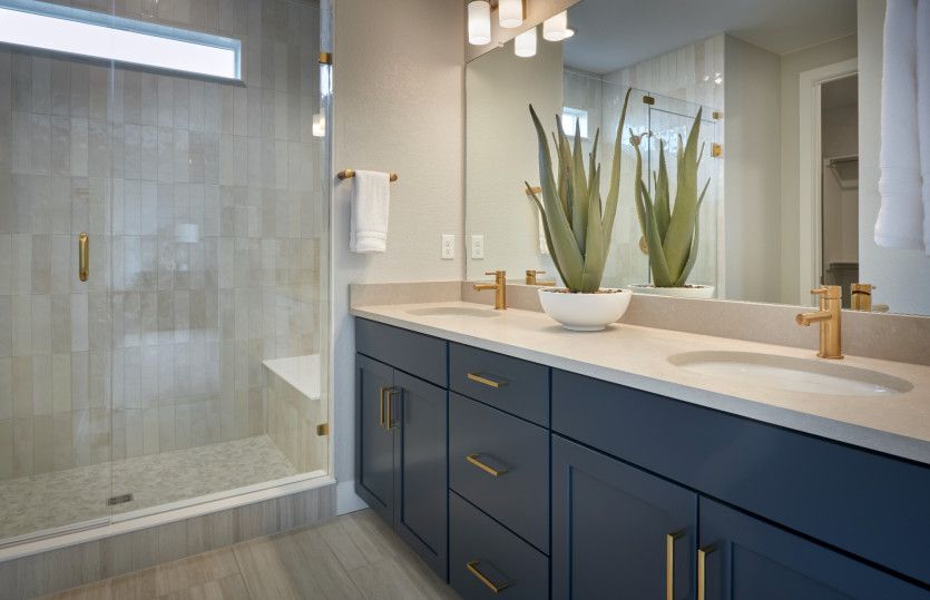 Enjoy a private owner's bath  with a glass, walk-in shower and dual sink vanity.