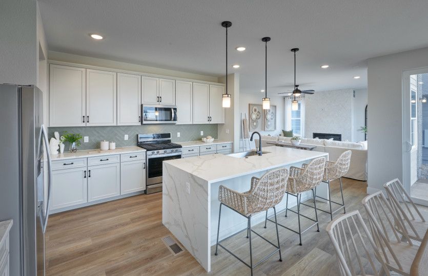 The Quincy kitchen shown with stunning white cabinets and a quartz island.