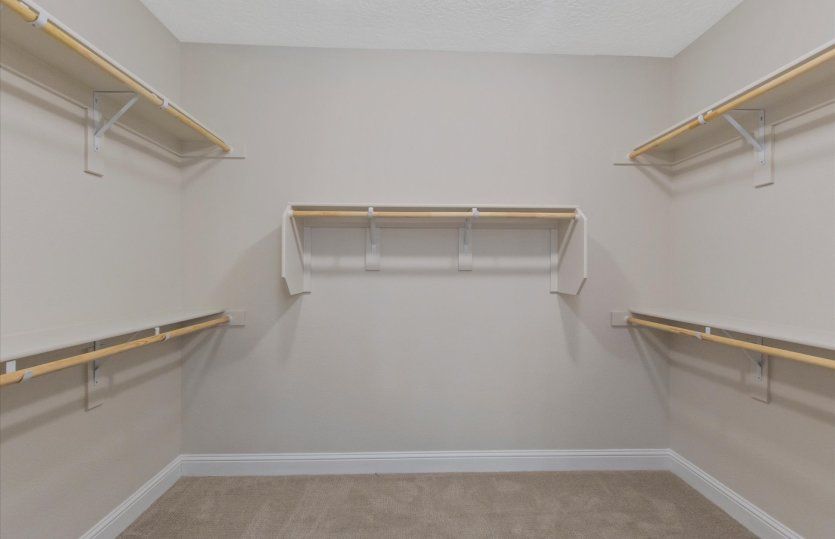 The walk-in closet is spacious and features plenty of built-in storage.