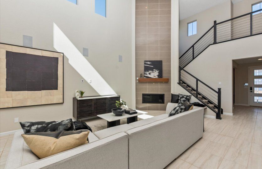 The Yucca gathering room featuring a tiled interior fireplace and a soaring ceiling.