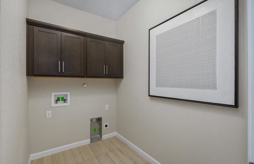The downstairs laundry room boasts additional storage space.
