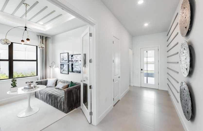 Sun-filled entry with decorative glass front door