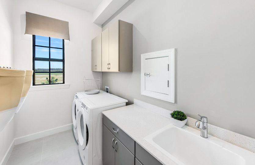 Spacious laundry room with sink and storage
