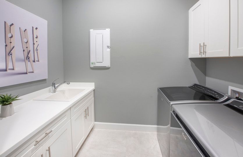 Laundry room with cabinets for extra storage