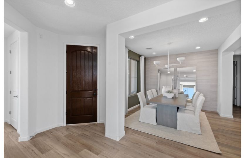 Foyer features beautiful wood-like flooring and interior archways leading to a formal dining room.