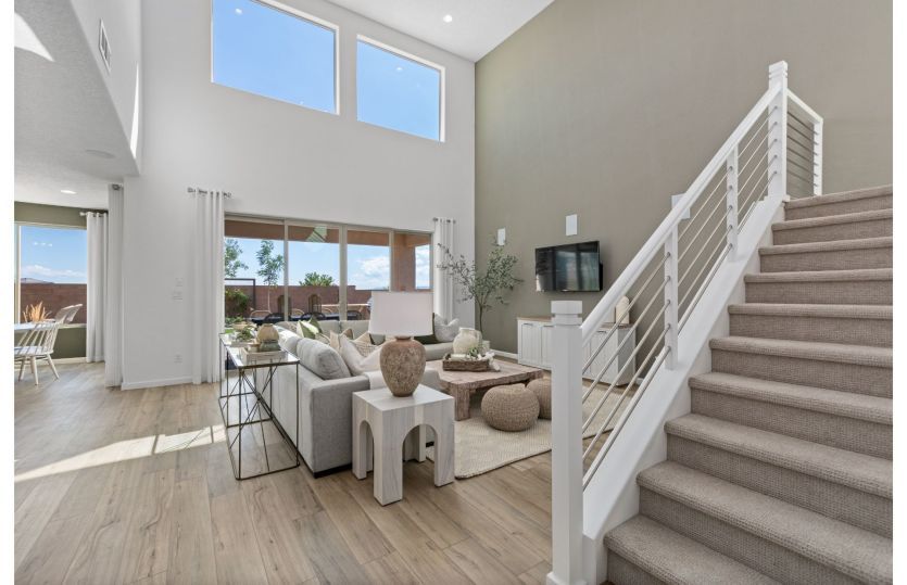 Modern railing adorns the staircase leading upstairs.