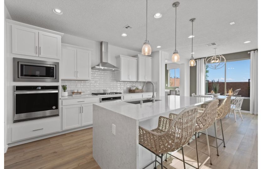 Stylish modern kitchen with stainless-steel appliances and accent lighting.