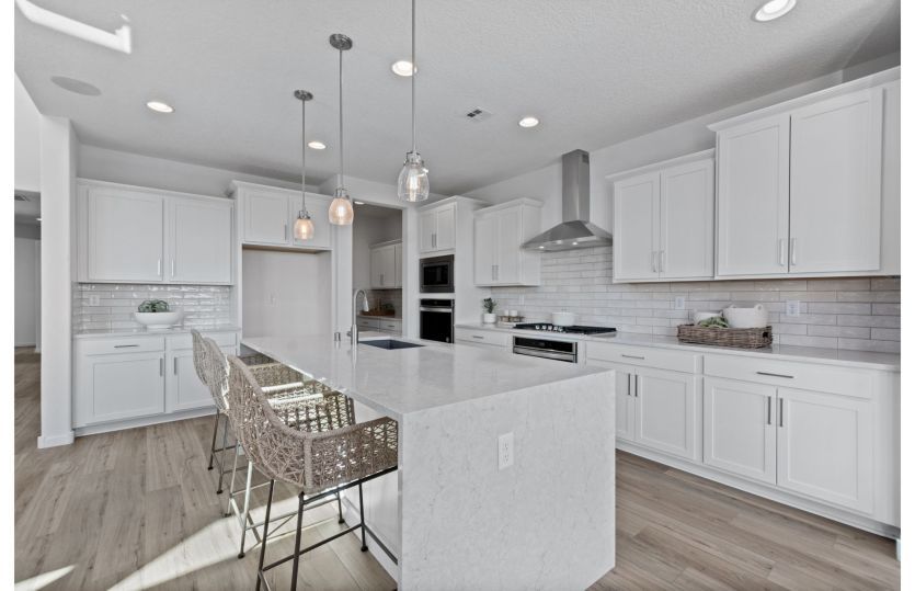 Open kitchen with breakfast bar seating at the waterfall island.