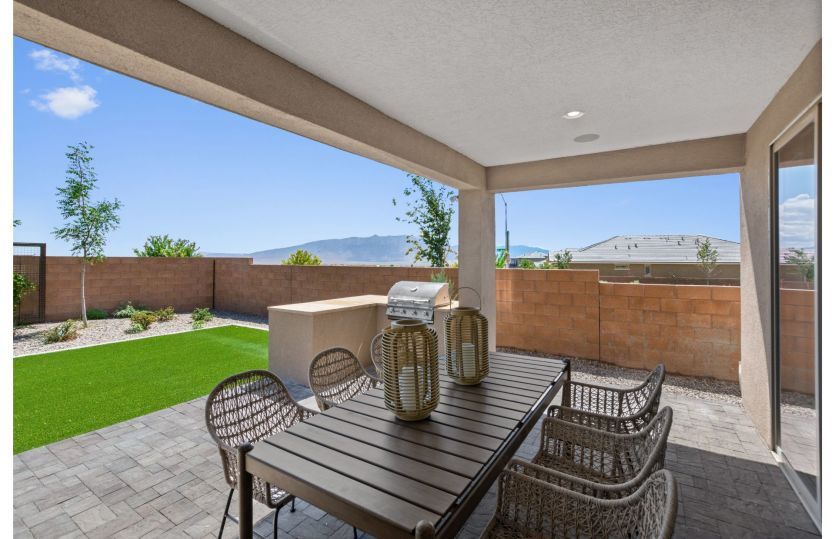Beautiful backyard and covered patio perfect for summer BBQs and dining al fresco.